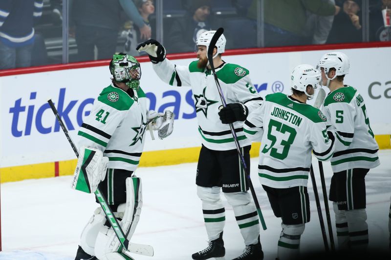 Nov 11, 2023; Winnipeg, Manitoba, CAN;  Dallas Stars goalie Scott Wedgewood (41) is congratulated by Dallas Stars defenseman Jani Hakanpaa (2) on his win against the Winnipeg Jets at the end of the third period at Canada Life Centre. Mandatory Credit: Terrence Lee-USA TODAY Sports