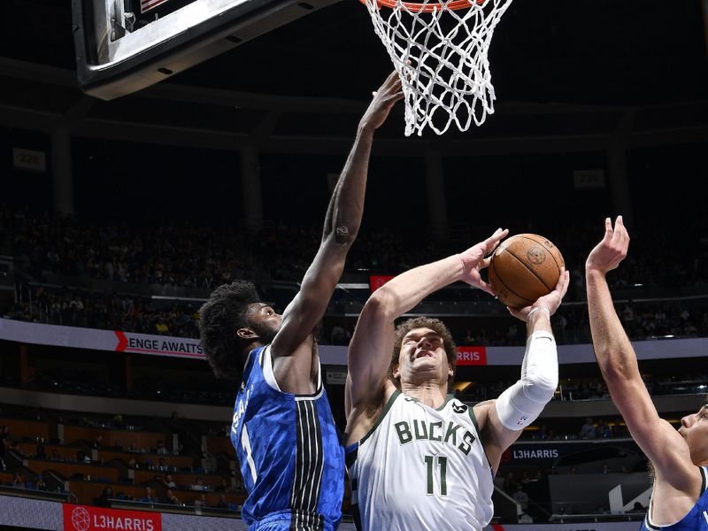 ORLANDO, FL - APRIL 14: Brook Lopez #11 of the Milwaukee Bucks drives to the basket during the game against the Orlando Magic on April 14, 2024 at Kia Center in Orlando, Florida. NOTE TO USER: User expressly acknowledges and agrees that, by downloading and or using this photograph, User is consenting to the terms and conditions of the Getty Images License Agreement. Mandatory Copyright Notice: Copyright 2024 NBAE (Photo by Fernando Medina/NBAE via Getty Images)