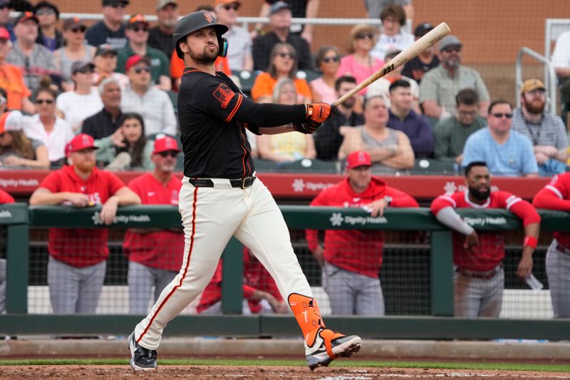 Feb 26, 2024; Scottsdale, Arizona, USA; San Francisco Giants third baseman JD Davis (7) hits against the Los Angeles Angels in the first inning at Scottsdale Stadium. Mandatory Credit: Rick Scuteri-USA TODAY Sports