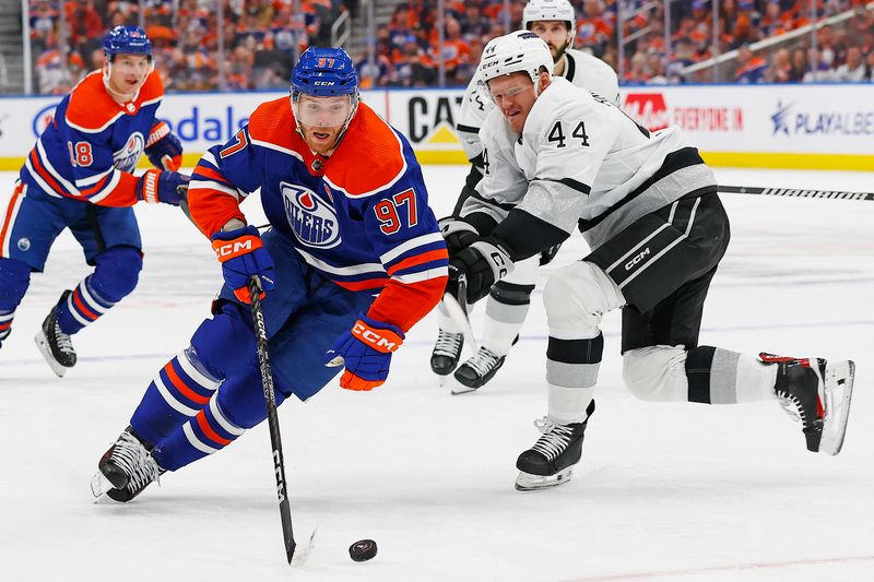 Apr 22, 2024; Edmonton, Alberta, CAN; Edmonton Oilers forward Connor McDavid (97) carries the puck around Los Angeles Kings defensemen Mikey Anderson (44) during the first period in game one of the first round of the 2024 Stanley Cup Playoffs at Rogers Place. Mandatory Credit: Perry Nelson-USA TODAY Sports