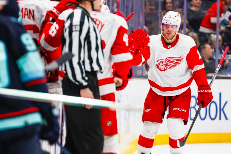 Feb 19, 2024; Seattle, Washington, USA; Detroit Red Wings right wing Daniel Sprong (17) high fives teammates on the bench after scoring a goal against the Seattle Kraken during the second period at Climate Pledge Arena. Mandatory Credit: Joe Nicholson-USA TODAY Sports