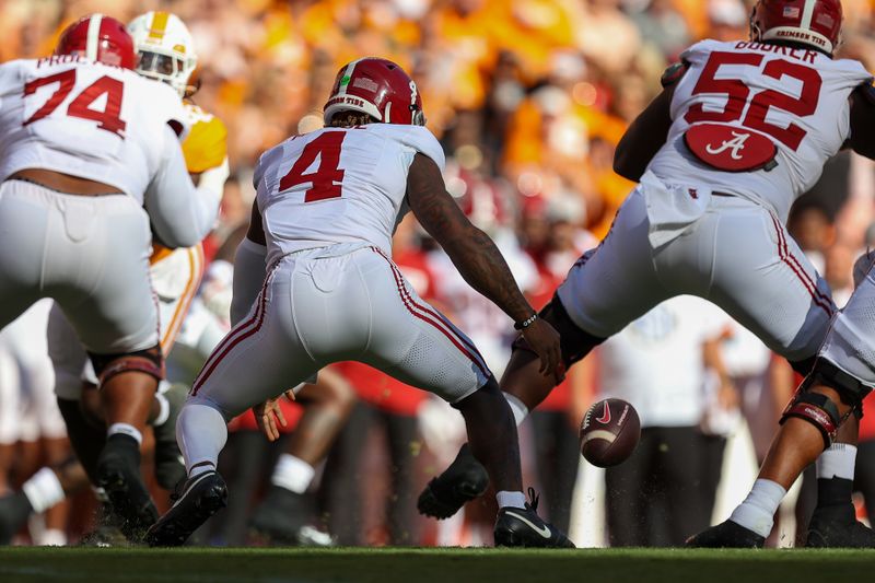 Oct 19, 2024; Knoxville, Tennessee, USA; Alabama Crimson Tide quarterback Jalen Milroe (4) fumbles the snap against the Tennessee Volunteers during the first quarter at Neyland Stadium. Mandatory Credit: Randy Sartin-Imagn Images