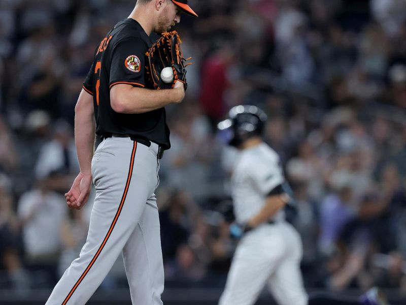 Sep 26, 2025; Bronx, New York, USA; Baltimore Orioles starting pitcher Trevor Rogers (28) reacts after giving up a two run home run to New York Yankees designated hitter Giancarlo Stanton (27) during the first inning at Yankee Stadium. Mandatory Credit: Brad Penner-Imagn Images