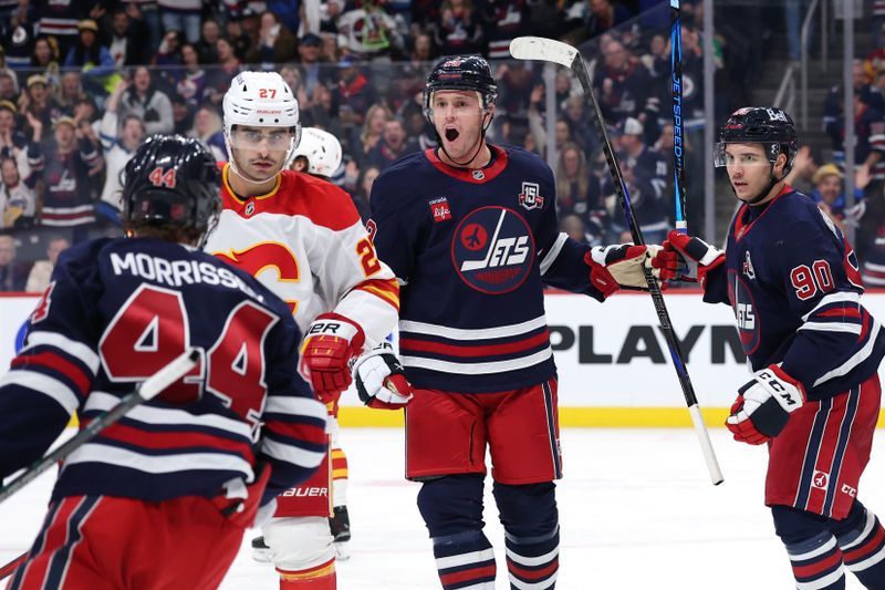 Oct 24, 2025; Winnipeg, Manitoba, CAN; Winnipeg Jets center Jonathan Toews (19) celebrates his goal against the Calgary Flames in the second period at Canada Life Centre. Mandatory Credit: James Carey Lauder-Imagn Images