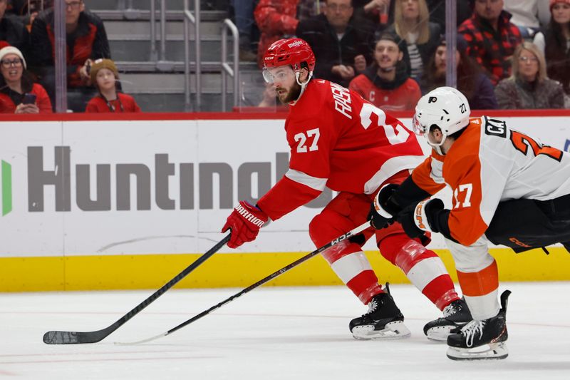 Jan 25, 2024; Detroit, Michigan, USA;  Detroit Red Wings center Michael Rasmussen (27) skates with the puck chased by Philadelphia Flyers left wing Noah Cates (27) in the second period at Little Caesars Arena. Mandatory Credit: Rick Osentoski-USA TODAY Sports