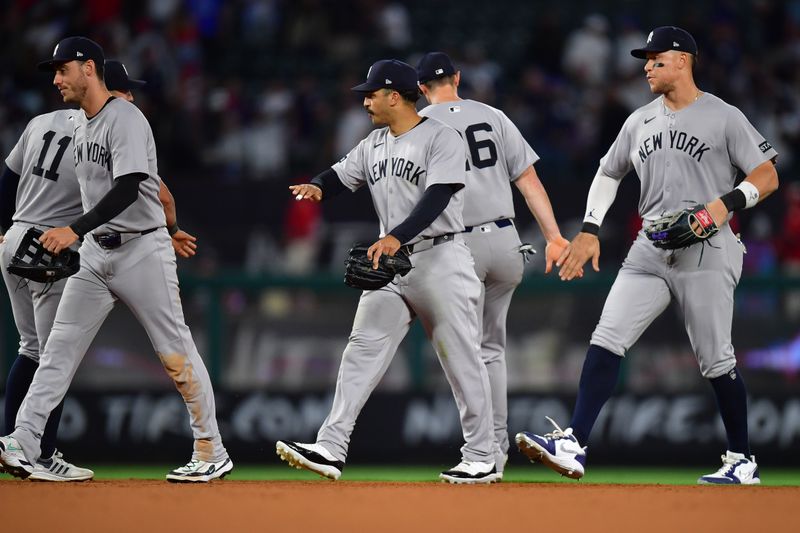 May 27, 2025; Anaheim, California, USA; New York Yankees left fielder Cody Bellinger (35) center fielder Trent Grisham (12) and right fielder Aaron Judge (99) celebrate the victory against the Los Angeles Angels at Angel Stadium. Mandatory Credit: Gary A. Vasquez-Imagn Images