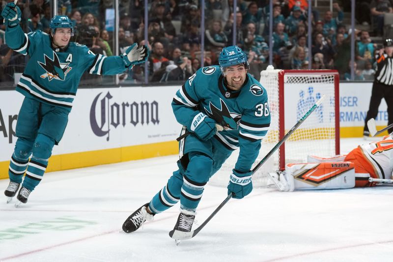 Oct 11, 2025; San Jose, California, USA; San Jose Sharks defenseman Mario Ferraro (38) reacts with center Macklin Celebrini (left) after scoring a goal against the Anaheim Ducks during the second period at SAP Center at San Jose. Mandatory Credit: Darren Yamashita-Imagn Images