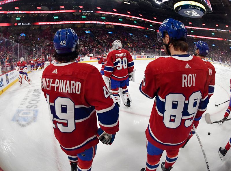 Jan 13, 2024; Montreal, Quebec, CAN; Montreal Canadiens forward Rafael Harvey-Pinard (49) and teammates goalie Cayden Primeau (30) and  forward Joshua Roy (89) during the warmup period before the game against the Edmonton Oilers at the Bell Centre. Mandatory Credit: Eric Bolte-USA TODAY Sports