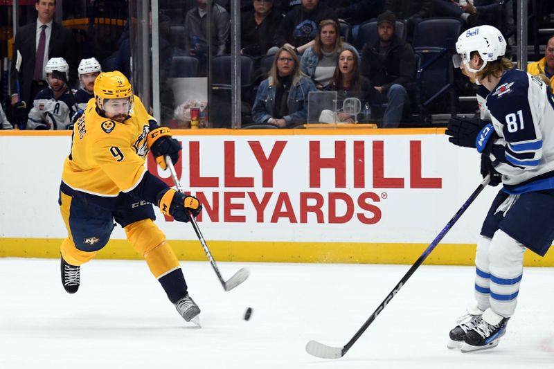 Nov 26, 2023; Nashville, Tennessee, USA; Nashville Predators left wing Filip Forsberg (9) shoots the puck during the third period against the Winnipeg Jets at Bridgestone Arena. Mandatory Credit: Christopher Hanewinckel-USA TODAY Sports