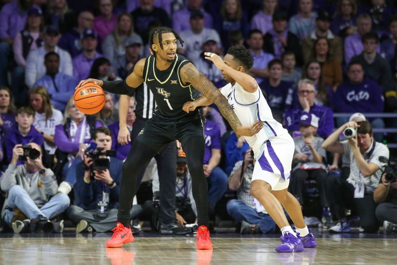 Jan 6, 2024; Manhattan, Kansas, USA; UCF Knights guard Antwann Jones (1) is guarded by Kansas State Wildcats guard Tylor Perry (2) during the first half at Bramlage Coliseum. Mandatory Credit: Scott Sewell-USA TODAY Sports