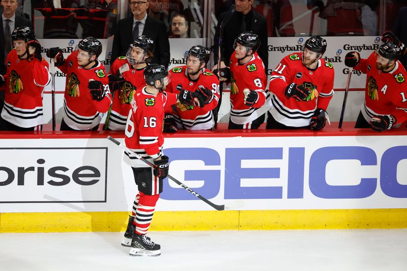 Mar 26, 2024; Chicago, Illinois, USA; Chicago Blackhawks center Jason Dickinson (16) celebrates with teammates after scoring against the Calgary Flames during the first period at United Center. Mandatory Credit: Kamil Krzaczynski-USA TODAY Sports