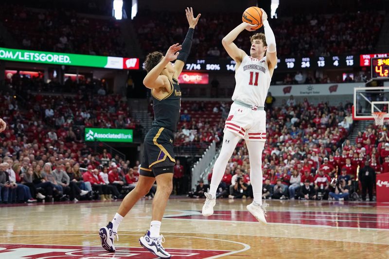 Jan 13, 2024; Madison, Wisconsin, USA; Wisconsin Badgers guard Max Klesmit (11) attempts a three point basket against Northwestern Wildcats guard Ty Berry (3) during the second half at the Kohl Center. Mandatory Credit: Kayla Wolf-USA TODAY Sports