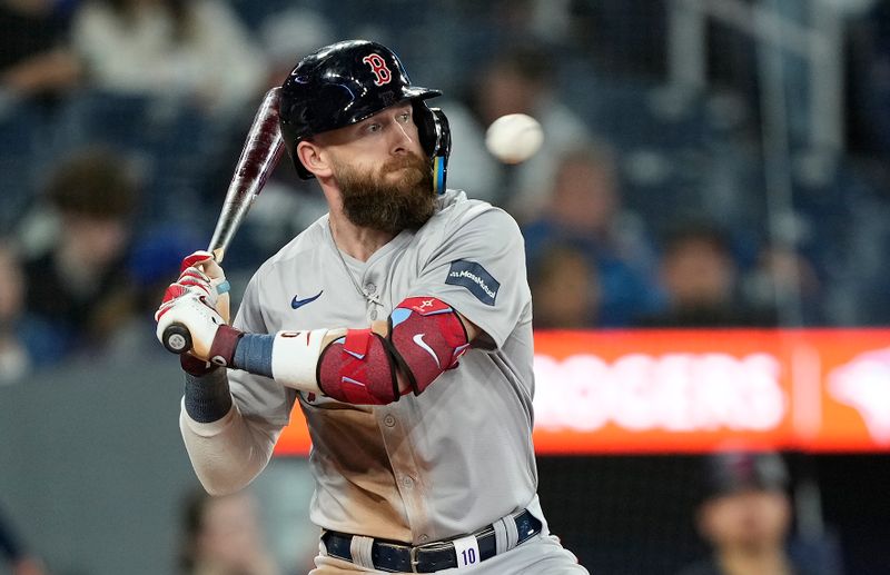 Sep 23, 2024; Toronto, Ontario, CAN; Boston Red Sox shortstop Trevor Story (10) avoids a pitch against the Toronto Blue Jays during the ninth inning at Rogers Centre. Mandatory Credit: John E. Sokolowski-Imagn Images