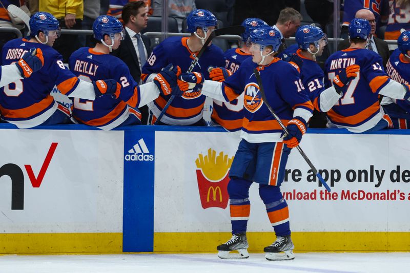 Apr 2, 2024; Elmont, New York, USA; New York Islanders right wing Simon Holmstrom (10) celebrates his goal against the Chicago Blackhawks during the third period at UBS Arena. Mandatory Credit: Thomas Salus-USA TODAY Sports