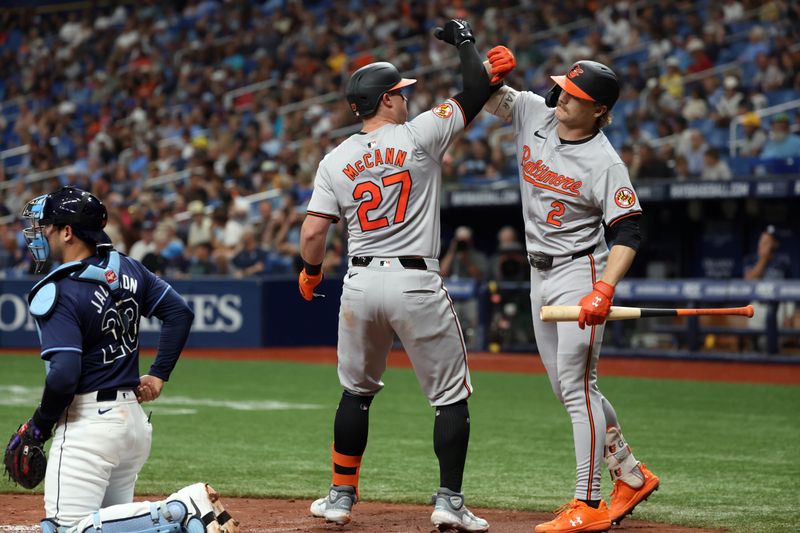 Jun 10, 2024; St. Petersburg, Florida, USA;  Baltimore Orioles catcher James McCann (27) celebrates with shortstop Gunnar Henderson (2) as he runs around the bases after he hit a home run during the third inning against the Tampa Bay Rays at Tropicana Field. Mandatory Credit: Kim Klement Neitzel-USA TODAY Sports