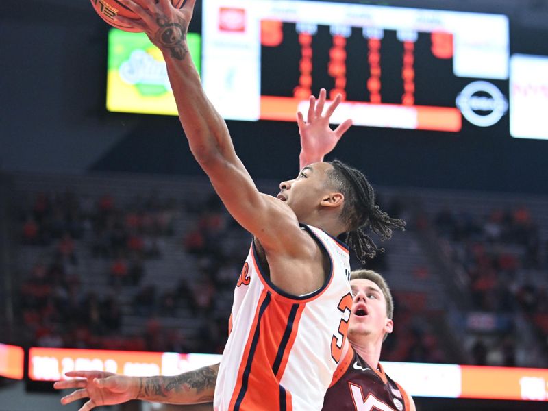 Feb 27, 2024; Syracuse, New York, USA; Syracuse Orange guard Judah Mintz shoots the ball as Virginia Tech Hokies guard Sean Pedulla defends in the second half at the JMA Wireless Dome. Mandatory Credit: Mark Konezny-USA TODAY Sports