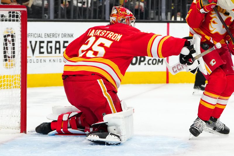 Jan 13, 2024; Las Vegas, Nevada, USA; Calgary Flames goaltender Jacob Markstrom (25) blocks a shot by the Vegas Golden Knights during the second period at T-Mobile Arena. Mandatory Credit: Stephen R. Sylvanie-USA TODAY Sports