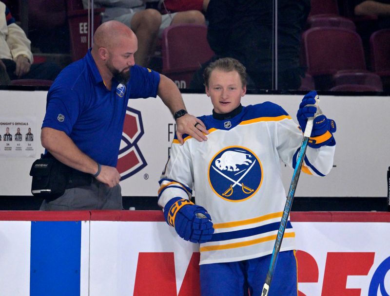 Oct 20, 2025; Montreal, Quebec, CAN; Trainer Bob Mowry talks to Buffalo Sabres defenseman Zach Metsa (73) during the warmup period before the game against the Montreal Canadiens at the Bell Centre. Mandatory Credit: Eric Bolte-Imagn Images