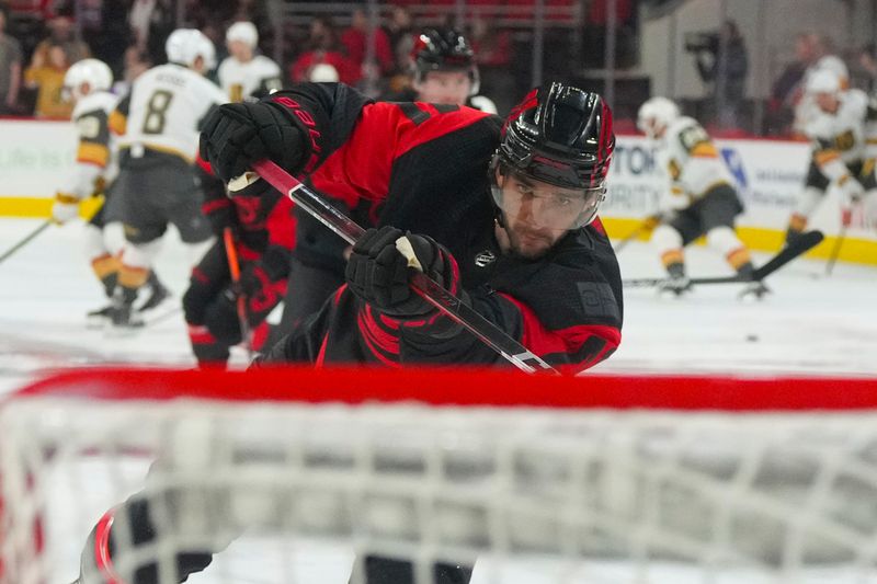 Mar 11, 2023; Raleigh, North Carolina, USA; Carolina Hurricanes defenseman Shayne Gostisbehere (41) takes a shot before the game against the Vegas Golden Knights at PNC Arena. Mandatory Credit: James Guillory-USA TODAY Sports