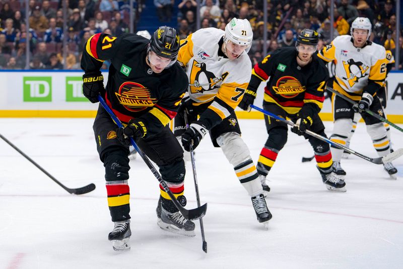 Oct 26, 2024; Vancouver, British Columbia, CAN; Pittsburgh Penguins forward Evgeni Malkin (71) stick checks Vancouver Canucks forward Nils Hoglander (21) during the first period at Rogers Arena. Mandatory Credit: Bob Frid-Imagn Images