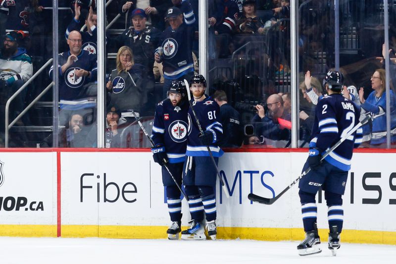 Mar 15, 2024; Winnipeg, Manitoba, CAN; Winnipeg Jets forward Kyle Connor (81) is congratulated by his team mates on his goal against the Anaheim Ducks during the first period at Canada Life Centre. Mandatory Credit: Terrence Lee-USA TODAY Sports