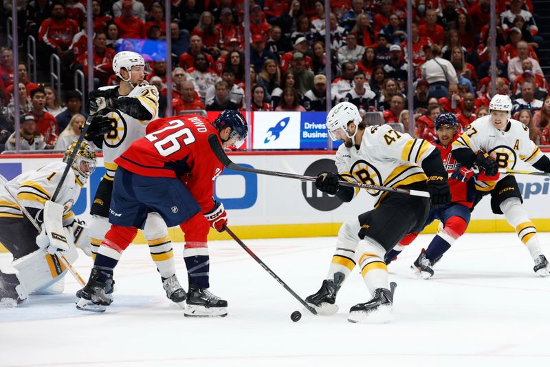 Oct 8, 2025; Washington, District of Columbia, USA;Washington Capitals center Nic Dowd (26) and Boston Bruins center Mark Kastelic (47) battle for the puck in front of Bruins goaltender Jeremy Swayman (1) during the first period  at Capital One Arena. Mandatory Credit: Geoff Burke-Imagn Images