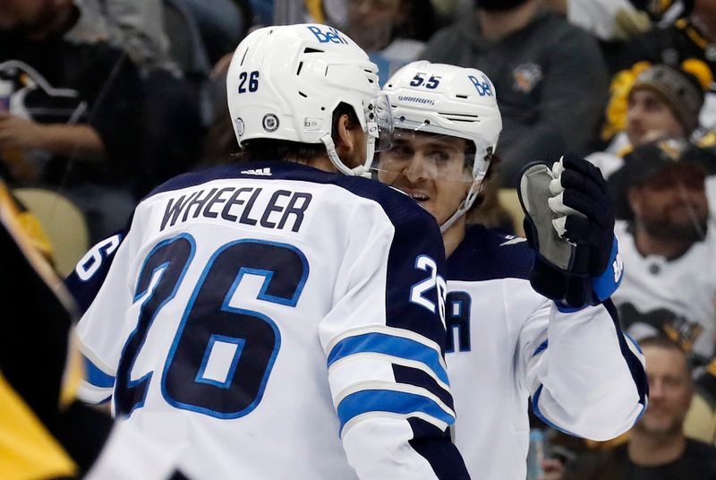 Jan 13, 2023; Pittsburgh, Pennsylvania, USA; Winnipeg Jets right wing Blake Wheeler (26) celebrates a goal by center Mark Scheifele (55) against the Pittsburgh Penguins during the second period at PPG Paints Arena. Mandatory Credit: Charles LeClaire-USA TODAY Sports