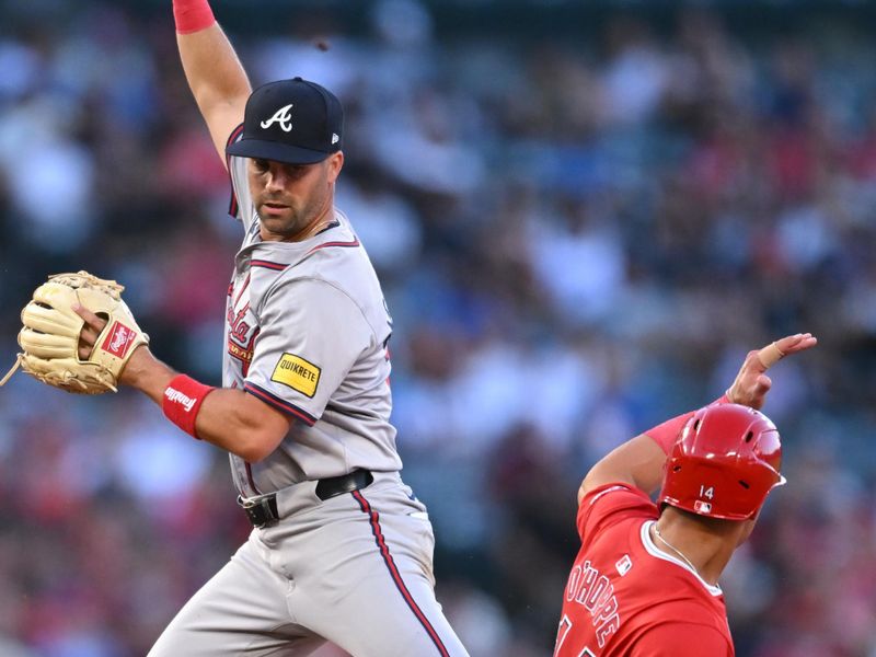 Aug 17, 2024; Anaheim, California, USA; Los Angeles Angels catcher Logan O'Hoppe (14) slides into second base against Atlanta Braves second baseman Whit Merrifield (15) during the second inning at Angel Stadium. Mandatory Credit: Jonathan Hui-USA TODAY Sports