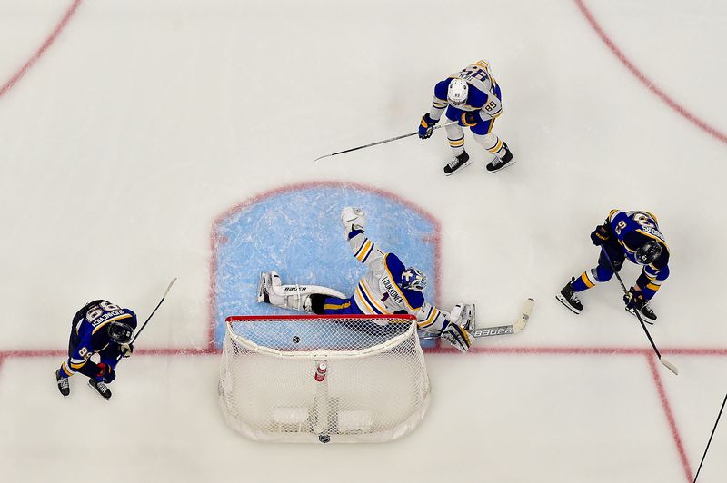 Nov 30, 2023; St. Louis, Missouri, USA;  St. Louis Blues left wing Jake Neighbours (63) shoots and scores against Buffalo Sabres goaltender Ukko-Pekka Luukkonen (1) during the third period at Enterprise Center. Mandatory Credit: Jeff Curry-USA TODAY Sports