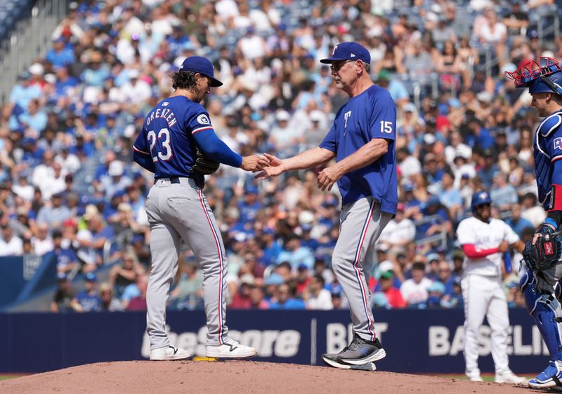 Jul 27, 2024; Toronto, Ontario, CAN; Texas Rangers starting pitcher Michael Lorenzen (23) is relieved by manager Bruce Bochy (15) against the Toronto Blue Jays during the first inning at Rogers Centre. Mandatory Credit: Nick Turchiaro-USA TODAY Sports