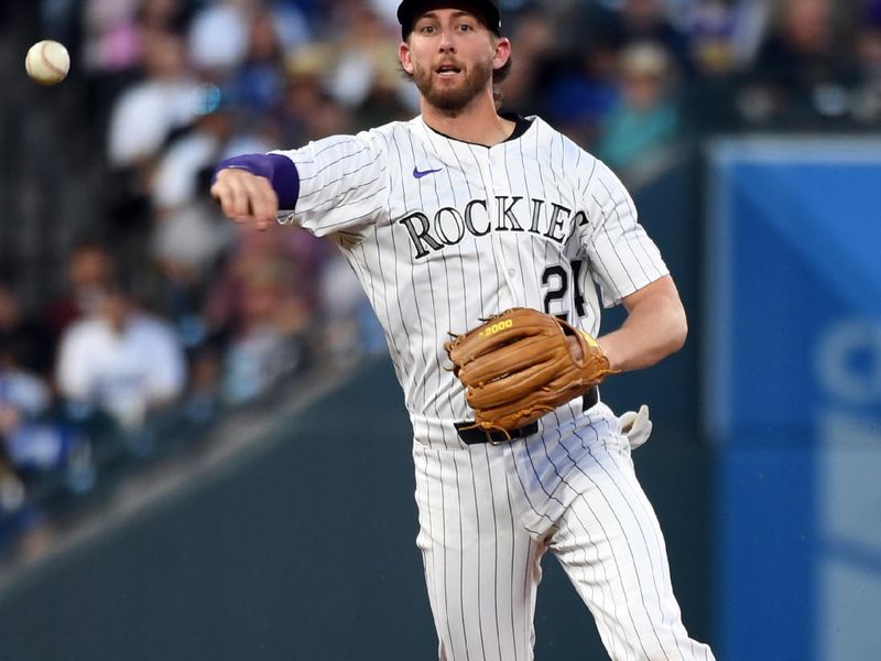 Jun 25, 2025; Denver, Colorado, USA; Colorado Rockies third base Ryan McMahon (24) throws the ball to first base for an out during the fourth inning against the Los Angeles Dodgers at Coors Field. Mandatory Credit: Christopher Hanewinckel-Imagn Images