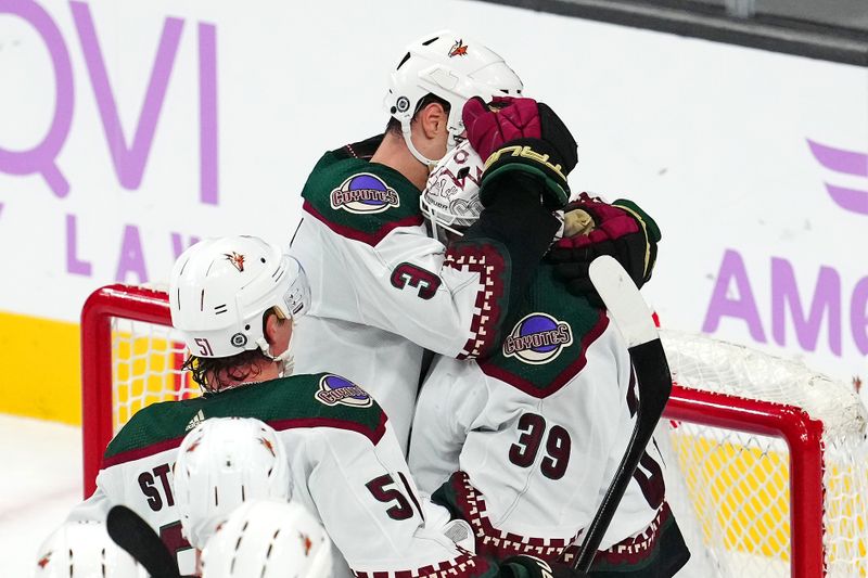 Nov 25, 2023; Las Vegas, Nevada, USA; Arizona Coyotes defenseman Josh Brown (3) congratulates goaltender Connor Ingram (39) after the Coyotes defeated the Vegas Golden Knights at T-Mobile Arena. Mandatory Credit: Stephen R. Sylvanie-USA TODAY Sports