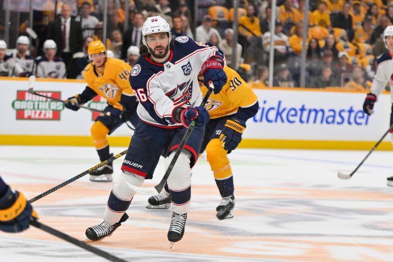 Oct 9, 2025; Nashville, Tennessee, USA; Columbus Blue Jackets right wing Kirill Marchenko (86) passes the puck N during the first period at Bridgestone Arena. Mandatory Credit: Steve Roberts-Imagn Images