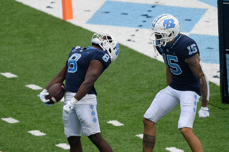 Oct 10, 2020; Chapel Hill, North Carolina, USA; North Carolina Tar Heels running back Michael Carter (8) reacts wide receiver Beau Corrales (15) after scoring a touchdown in the third quarter at Kenan Memorial Stadium. Mandatory Credit: Bob Donnan-USA TODAY Sports