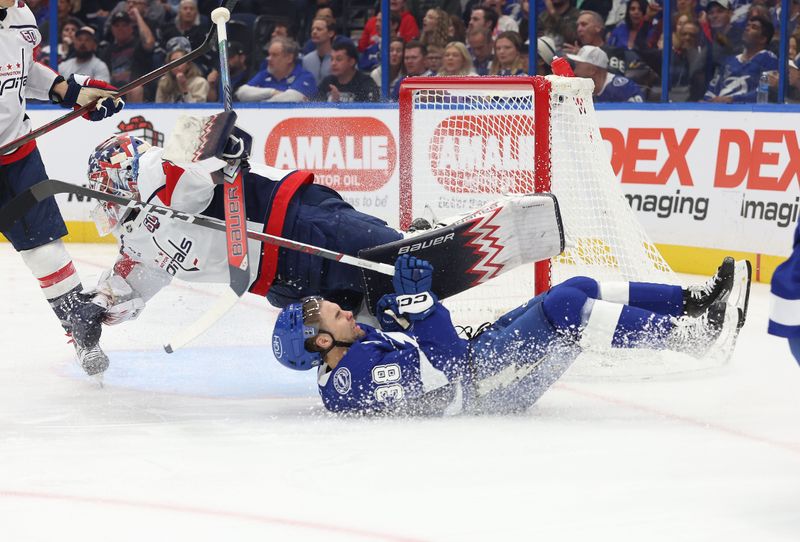 Nov 27, 2024; Tampa, Florida, USA; Tampa Bay Lightning left wing Brandon Hagel (38) and Washington Capitals goaltender Charlie Lindgren (79) skate into each other during the first period at Amalie Arena. Mandatory Credit: Kim Klement Neitzel-Imagn Images