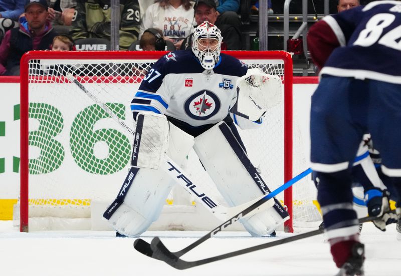 Mar 28, 2026; Denver, Colorado, USA; Winnipeg Jets goaltender Connor Hellebuyck (37) defends the net in the first period against the Colorado Avalanche at Ball Arena. Mandatory Credit: Ron Chenoy-Imagn Images