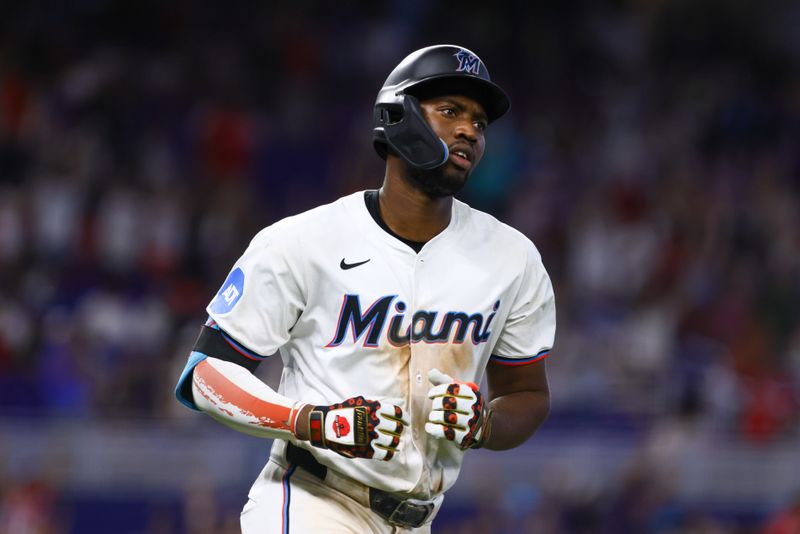 Jul 4, 2024; Miami, Florida, USA; Miami Marlins right fielder Jesus Sanchez (12) circles the bases after hitting a two-run home run against the Boston Red Sox during the eleventh inning at loanDepot Park. Mandatory Credit: Sam Navarro-USA TODAY Sports