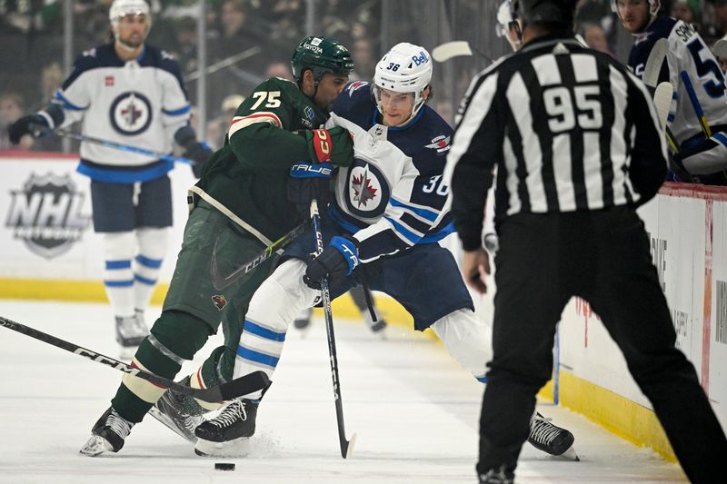 Apr 11, 2023; Saint Paul, Minnesota, USA;  Minnesota Wild forward Ryan Reaves (75) bumps Winnipeg Jets forward Morgan Barron (36) off of the puck during the first period at at Xcel Energy Center. Mandatory Credit: Nick Wosika-USA TODAY Sports