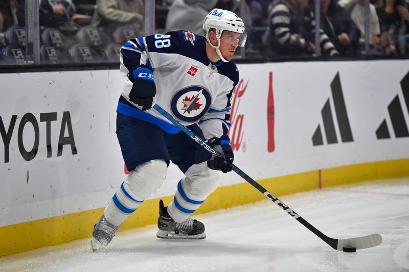 Dec 13, 2023; Los Angeles, California, USA; Winnipeg Jets defenseman Nate Schmidt (88) controls the puck against the Los Angeles Kings during the second period at Crypto.com Arena. Mandatory Credit: Gary A. Vasquez-USA TODAY Sports