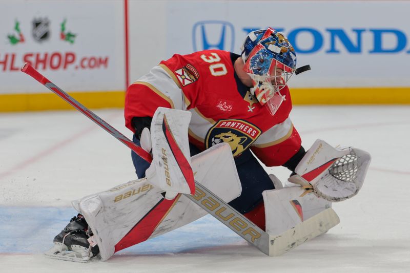 Nov 30, 2024; Sunrise, Florida, USA; Florida Panthers goaltender Spencer Knight (30) makes a save against Carolina Hurricanes center Martin Necas (not pictured) during the first period at Amerant Bank Arena. Mandatory Credit: Sam Navarro-Imagn Images