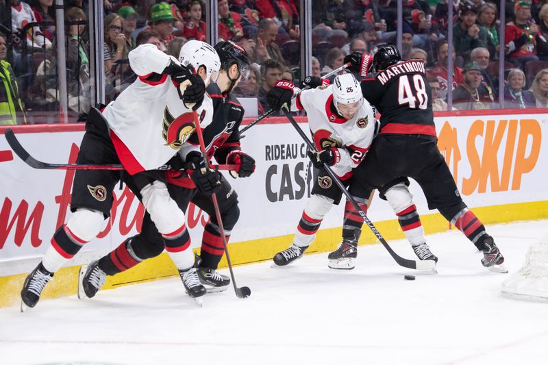 Mar 17, 2024; Ottawa, Ontario, CAN; Ottawa Senators defenseman Erik Brannstrom (26) battles with Carolina Hurricanes left wing Jordan Martinook (48) in the second period at the Canadian Tire Centre. Mandatory Credit: Marc DesRosiers-USA TODAY Sports