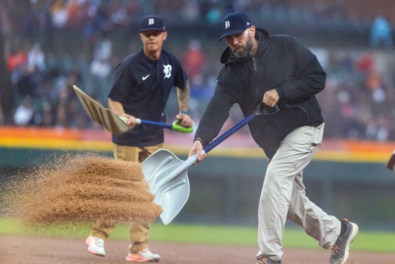 May 22, 2025; Detroit, Michigan, USA; The Detroit Tigers grounds crew spreads dry dirt on the infield in the fourth inning against the Cleveland Guardians at Comerica Park. Mandatory Credit: David Reginek-Imagn Images