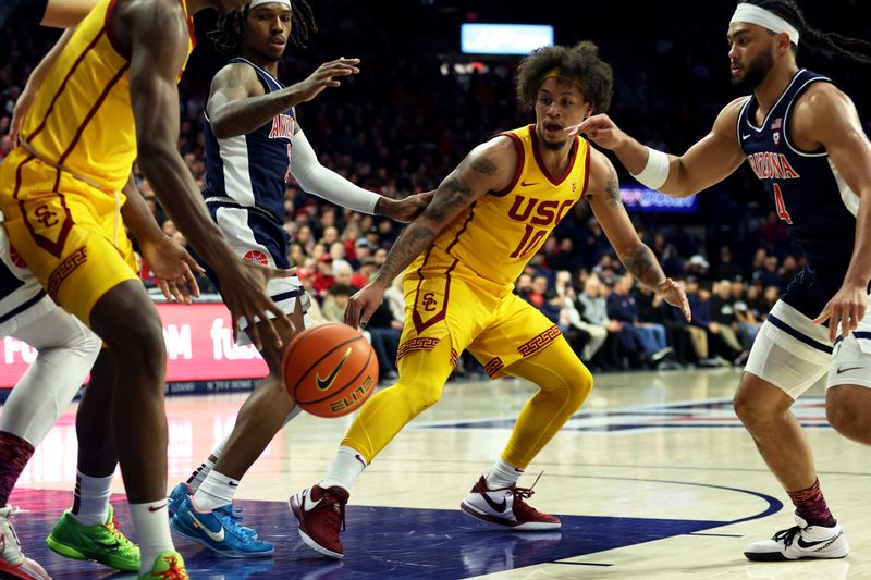 sJan 17, 2024; Tucson, Arizona, USA; USC Trojans forward DJ Rodman (10) makes a pass against Arizona Wildcats guard Kylan Boswell (4) during the first half at McKale Center. Mandatory Credit: Zachary BonDurant-USA TODAY Sports