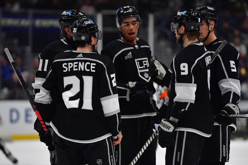 Dec 13, 2023; Los Angeles, California, USA; Los Angeles Kings right wing Quinton Byfield (55) speaks with center Anze Kopitar (11) defenseman Jordan Spence (21) right wing Adrian Kempe (9) and defenseman Andreas Englund (5) during a stoppage in play in the second period at Crypto.com Arena. Mandatory Credit: Gary A. Vasquez-USA TODAY Sports