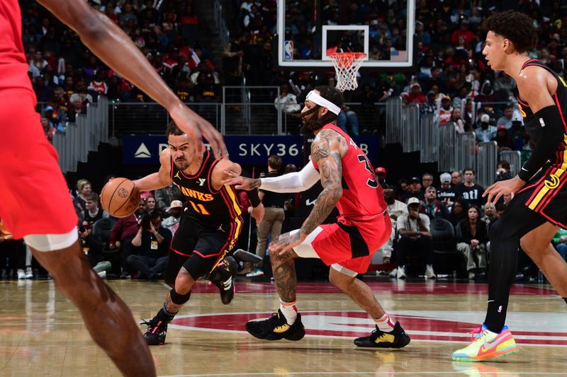 ATLANTA, GA - February 23: Trae Young #11 of the Atlanta Hawks handles the ball during the game against the Toronto Raptors on February 23, 2024 at State Farm Arena in Atlanta, Georgia.  NOTE TO USER: User expressly acknowledges and agrees that, by downloading and/or using this Photograph, user is consenting to the terms and conditions of the Getty Images License Agreement. Mandatory Copyright Notice: Copyright 2024 NBAE (Photo by Scott Cunningham/NBAE via Getty Images)