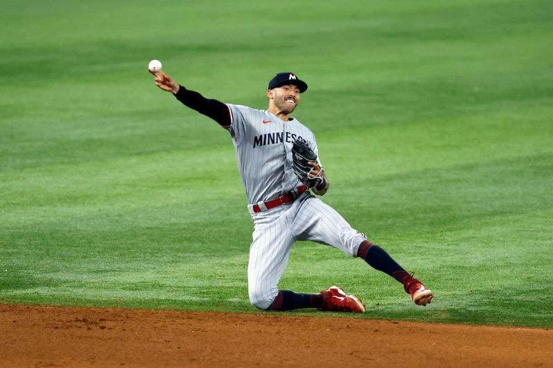 Sep 2, 2023; Arlington, Texas, USA; Minnesota Twins shortstop Carlos Correa (4) throws to first base in the seventh inning against the Texas Rangers at Globe Life Field. Mandatory Credit: Tim Heitman-USA TODAY Sports