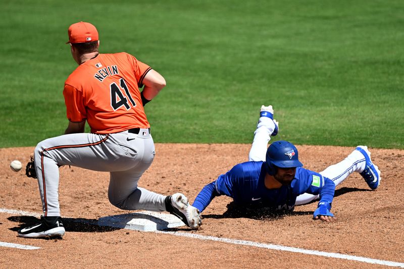 Mar 19, 2024; Dunedin, Florida, USA; Toronto Blue Jays centerfielder Kevin Kiermaier (39) dives back to first base as Baltimore Orioles first baseman Tyler Nevin (41) waits for the ball in the second inning of the spring training game  at TD Ballpark. Mandatory Credit: Jonathan Dyer-USA TODAY Sports