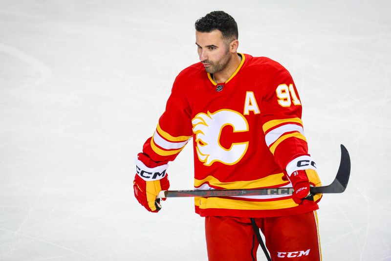 Mar 4, 2024; Calgary, Alberta, CAN; Calgary Flames center Nazem Kadri (91) skates during the warmup period against the Seattle Kraken at Scotiabank Saddledome. Mandatory Credit: Sergei Belski-USA TODAY Sports