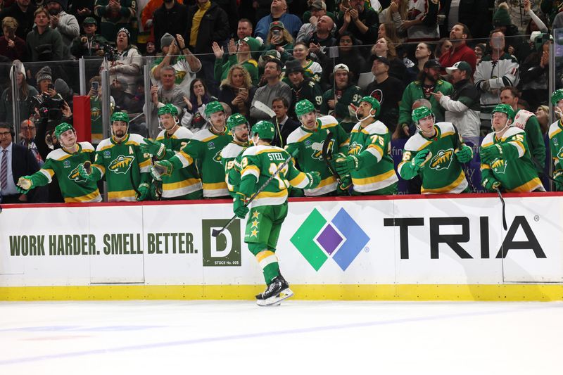 Jan 4, 2023; Saint Paul, Minnesota, USA;  Minnesota Wild left wing Matt Boldy (12) celebrates his goal with teammates during the second period at Xcel Energy Center. Mandatory Credit: Bruce Fedyck-USA TODAY Sports