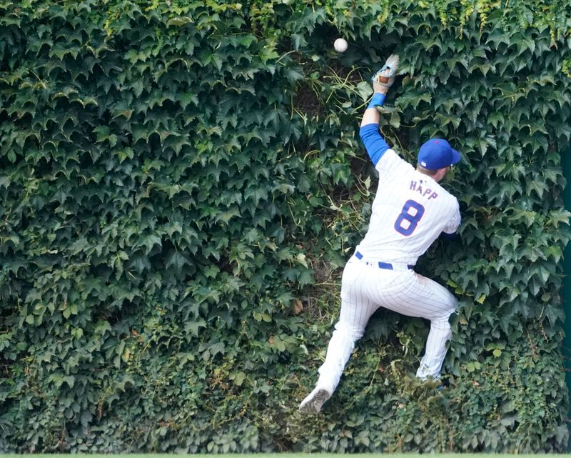 Aug 3, 2024; Chicago, Illinois, USA; Chicago Cubs outfielder Ian Happ (8) can’t catch a triple hit by St. Louis Cardinals outfielder Tommy Pham (not pictured) during the ninth inning at Wrigley Field. Mandatory Credit: David Banks-USA TODAY Sports